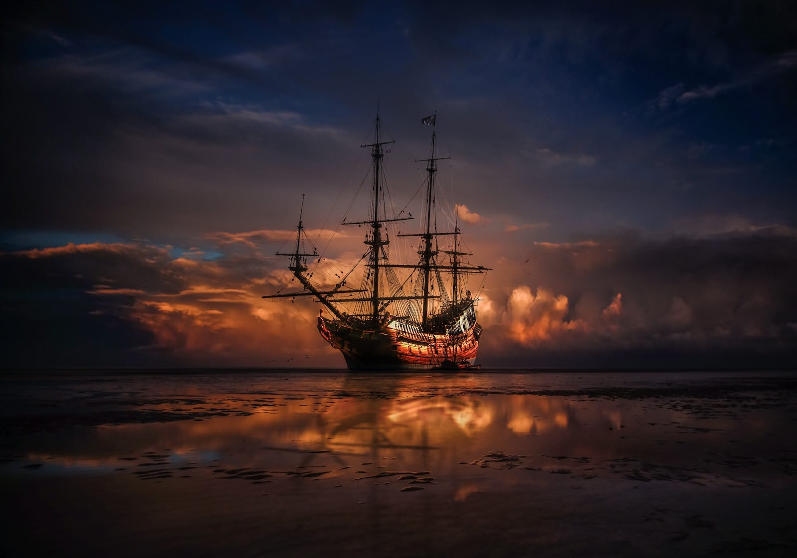 brown ship on sea during sunset